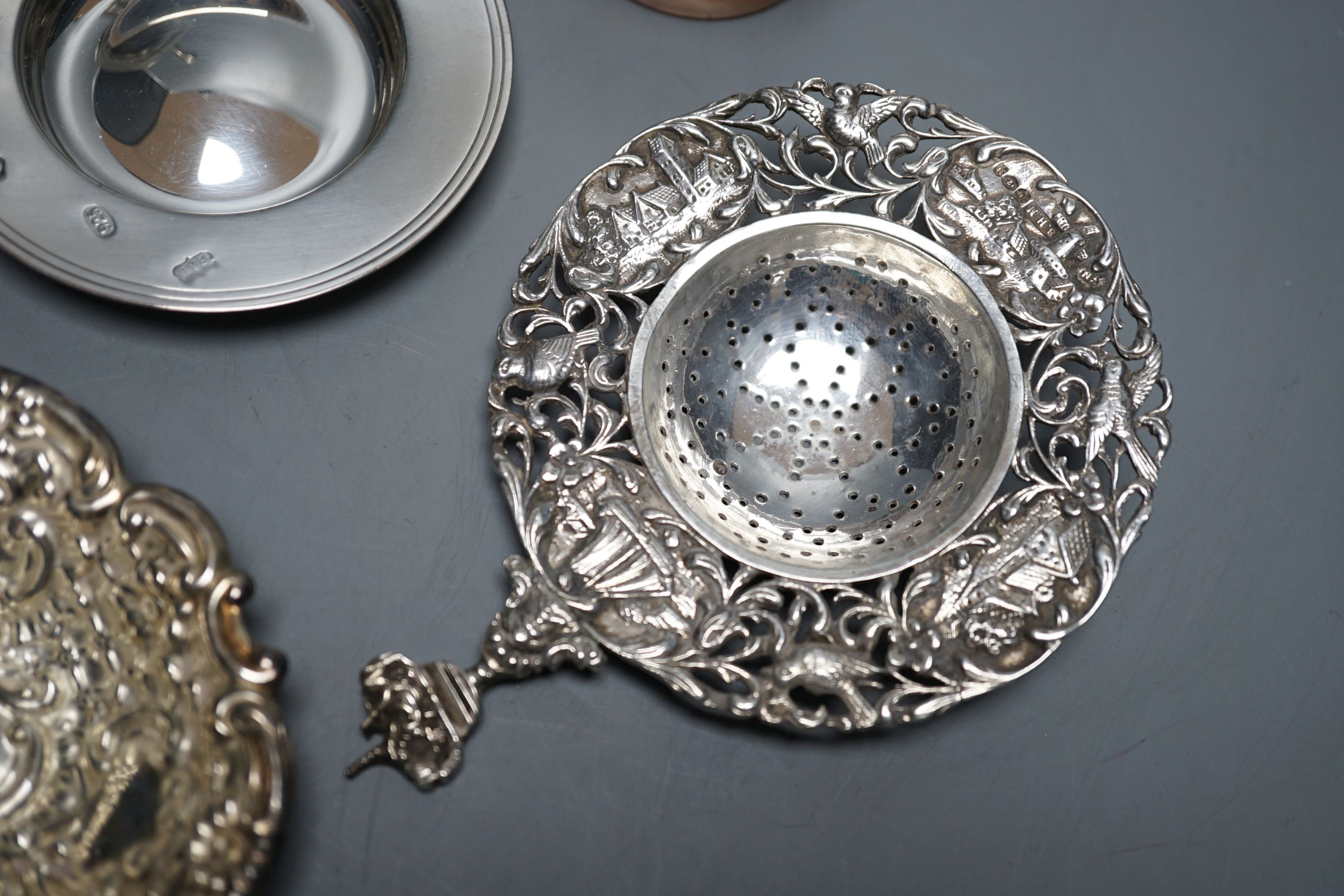 A late Victorian silver mustard, Sheffield, 1895, two small silver armada dishes, a silver bonbon dish, silver tea strainer(a.f.) and a silver mounted glass toilet jar.